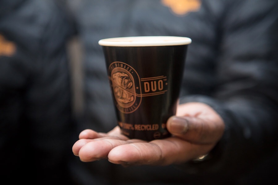 A Café Duo coffee cup being served